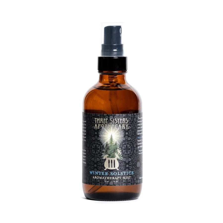 Brown glass bottle with black label featuring a winter tree design on a white background label "winter solstice aromatherapy mist"