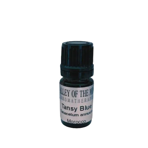Bottle of Valley of the Moon Tansy Blue essential oil on a white background