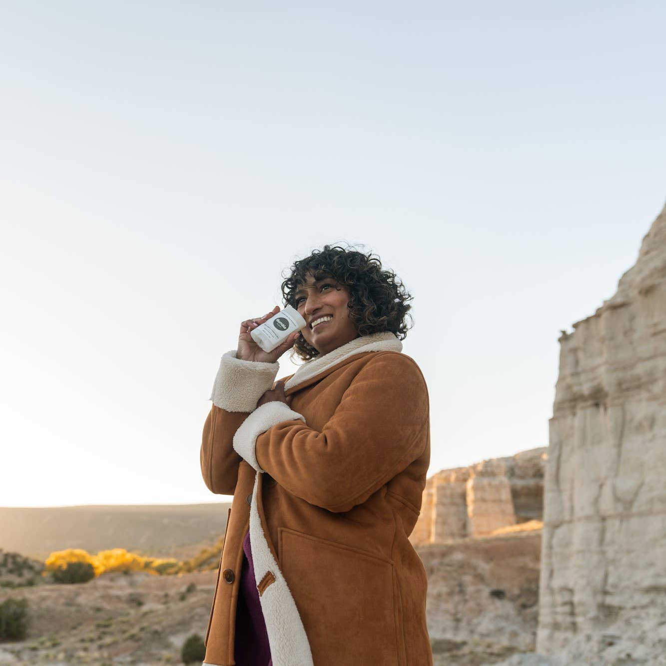 Woman outdoors holding Humble vegan deodorant – Palo Santo & Frankincense scent for sensitive skin – natural, baking soda free – www.aromathyme.com