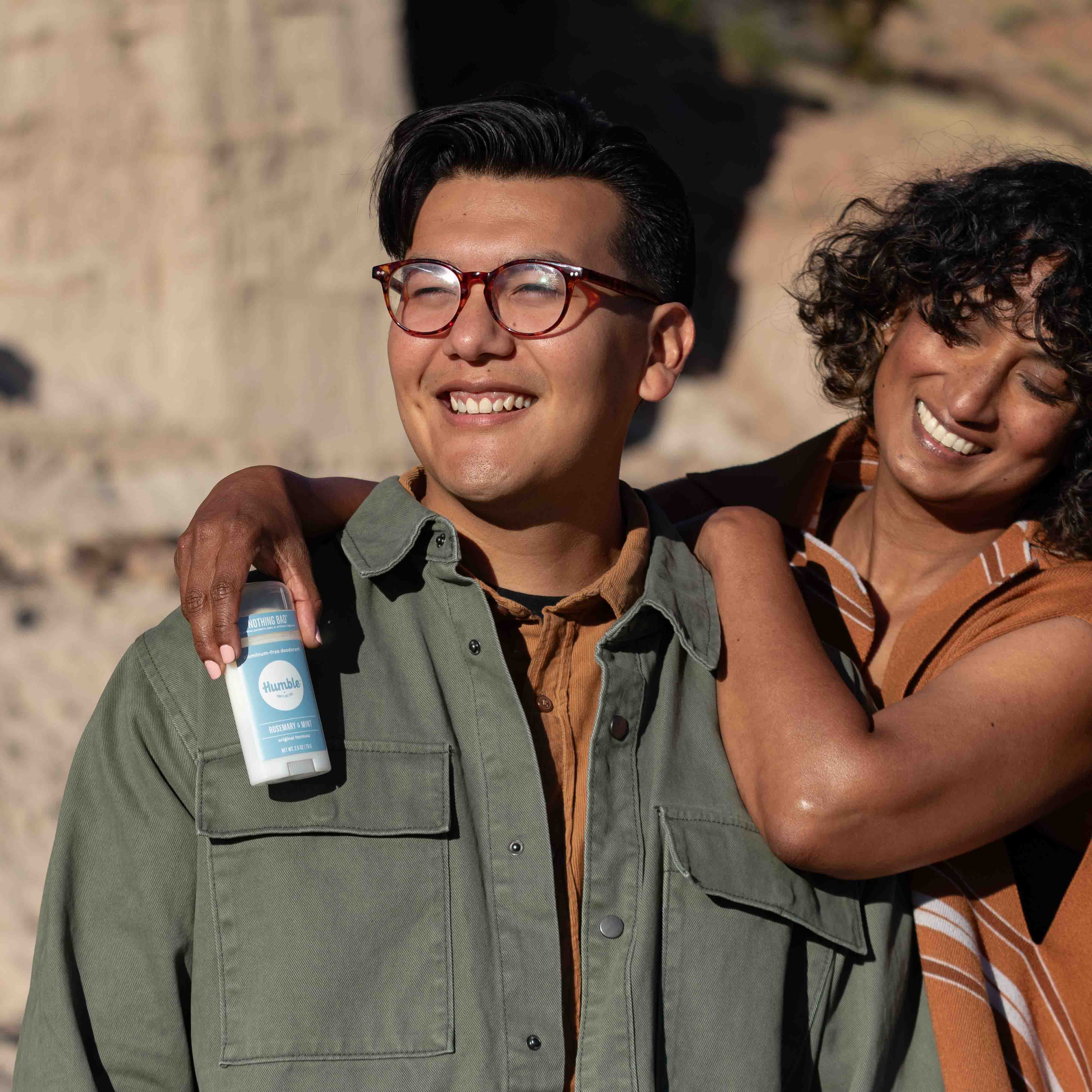 Man and woman outdoors holding rosemary mint humble brand original formula aluminum free deodorant